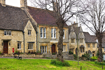 Wall Mural - Beautiful stone houses along a quaint street in the Cotswolds village of Burford, England