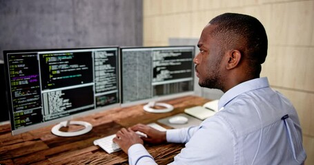 African American Coder Using Computer At Desk
