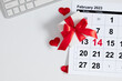 © prime1001 - Valentine's Day background. Date February 14 on calendar 2023. office table desk gift box and valentine hearts. Valentines day concept. Flat lay, top view, copy space