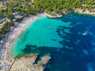 Wall Mural - Ibiza Cala Bassa beach with turquoise water, aerial views