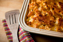 A Pan Of Macaroni And Cheese Baked With Organic Acorn Squash Sits Alongside A Spatula In A Kitchen In Seattle, Washington.