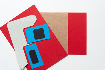 abstract paper background with blue square and black box, red and brown paper cards, and abstract gray paper shape