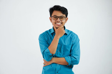 smiling employee asian man with glasses while holding the chin looking camera wearing blue shirt isolated on white background