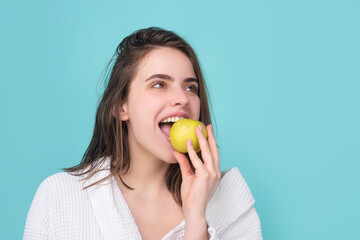 Woman with apples. Young woman eating apple over blue isolated background. Bitten apple with healthy teeth. Healthy diet fruits. Girl eat apple.