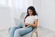 © SHOTPRIME STUDIO - Woman freelancer works in laptop via internet over startup at home sitting on chair, technology in business