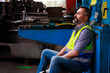 © NVB Stocker - Tired hot wiping sweat. Portrait hispanic latin male engineer factory manager worker and mechanic sitting in factory workplace