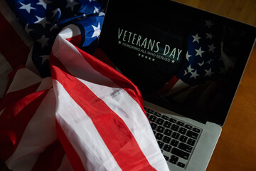 laptop with usa flag and inscription veterans day.