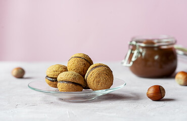 Hazelnut biscuits baci di dama or lady's kisses are traditional Italian dessert made as a sandwich with two cookies and chocolate cream. 