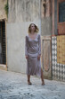 © triocean - Fashionable tourist woman in silk beige dress in the streets of Old town of Sibenik, Croatia