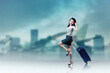 © Creativa Images - tourist woman in casual clothes pulling a suitcase