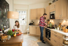 Couple In Kitchen And Preparing Food, Munich, Bavaria, Germany