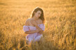 © KatrinaQQ - portrait of a happy young girl in a dress in a wheat field at sunset, the concept of peace and unity with nature