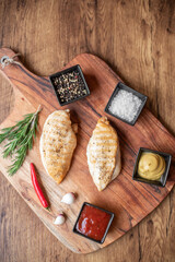 Wall Mural - grilled chicken fillet on wooden background