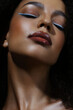 Close-up of beautiful young woman. Arrows, glowing dark skin, wet lip gloss