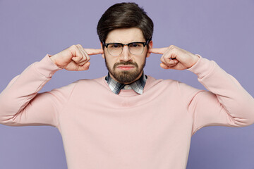 Wall Mural - Young sad mad caucasian IT man he wear casual clothes pink sweater glasses cover ears with hands fingers do not want to listen scream isolated on plain pastel light purple background studio portrait.