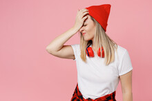 Young Dissatisfied Woman Wear White T-shirt Red Hat Put Hand On Face Facepalm Epic Fail Mistaken Omg Gesture Isolated On Plain Pastel Light Pink Background Studio Portrait. People Lifestyle Concept.