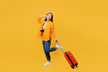 Young Woman In Summer Casual Clothes Stand With Suitcase Bag Hold Face Look Aside Isolated On Plain Yellow Background. Tourist Travel Abroad In Free Time Rest Getaway Air Flight Trip Journey Concept