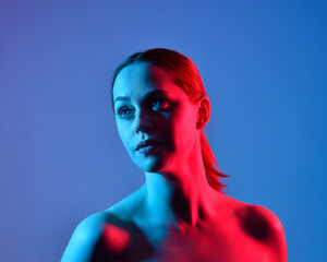 Sticker - Head and shoulders close up portrait of pretty girl with expressive facial expressions, with  colourful neon gel lighting, isolated on studio background.