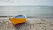 A small yellow fishing boat on the shore of a beach on the Baltic Sea in Poland
