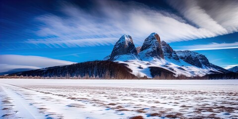 Wall Mural - A snow covered plain with snowy mountains in the background. 