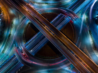 Poster -  car traffic transportation above circle roundabout road in Asian city. Drone aerial view fly in circle, high angle. Public transport or commuter city life concept, expressway