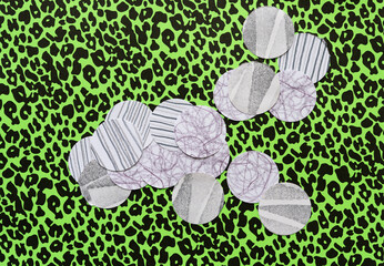 Sticker - scattered paper circles with curly and straight lines on green paper with black spots