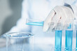 © Pattraporn - Scientist experimental in laboratory with test tube and beaker for medical research