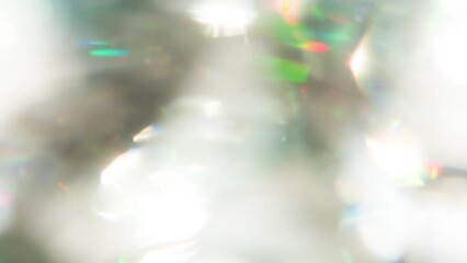 Wall Mural - Light Through the Thickness of a Diamond. Loop. The light passes through the facets of a slowly rotating diamond and creates repetitive sparkling highlights and rainbow colors