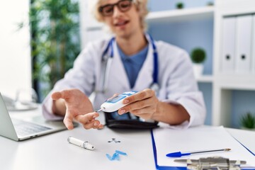 Sticker - Young blond man doctor smiling confident measuring glucose at clinic