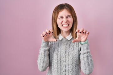 Sticker - Beautiful woman standing over pink background smiling funny doing claw gesture as cat, aggressive and sexy expression