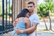 © Krakenimages.com - Man and woman couple smiling confident hugging each other at street