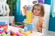© Krakenimages.com - Adorable blonde toddler playing with construction blocks standing at kindergarten