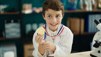 Poster - Adorable hispanic boy student smiling confident holding gold medal at laboratory classroom