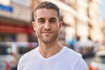 Canvas Print - Young caucasian man smiling confident standing at street