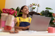 © Krakenimages.com - Young african american woman florist smiling confident using laptop at flower shop