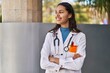© Krakenimages.com - Young african american woman doctor standing with arms crossed gesture at street