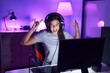 © Krakenimages.com - Young beautiful hispanic woman streamer playing video game with winner expression at gaming room