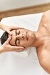 © Krakenimages.com - Young hispanic man relaxed having facial massage at beauty center