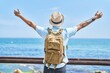 © Krakenimages.com - African american man tourist walking on back view with arms open at seaside