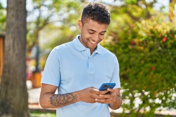 Poster - African american man smiling confident using smartphone at park