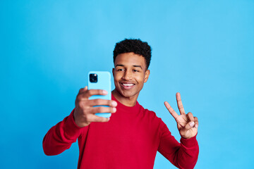 Cheerful black man showing victory sign