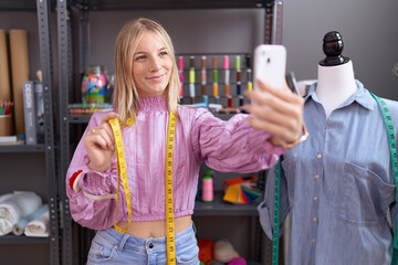 Canvas Print - Young blonde woman tailor smiling confident make selfie by smartphone at tailor shop