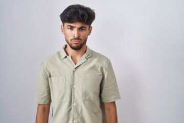 Canvas Print - Arab man with beard standing over white background skeptic and nervous, frowning upset because of problem. negative person.