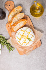 Wall Mural - Baked camembert soft cheese. Grilled brie with toasts and rosemary. 