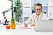 © Krakenimages.com - Young hispanic woman wearing nutritionist uniform writing on clipboard at clinic