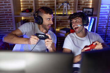 Poster - Two hispanic men streamers playing video game using joystick at gaming room