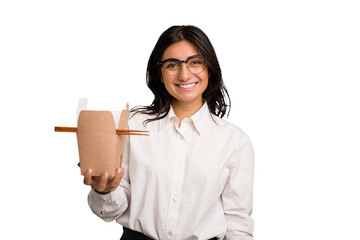 Wall Mural - Young business indian woman eating takeaway noodles cut out isolated happy, smiling and cheerful.