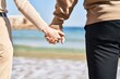 © Krakenimages.com - Mand and woman couple standing together with hands together at seaside