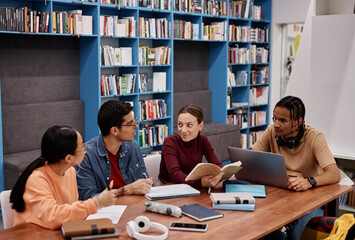 Wall Mural - Diverse group of young people studying together