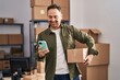 © Krakenimages.com - Young caucasian man ecommerce business worker using smartphone holding package at office